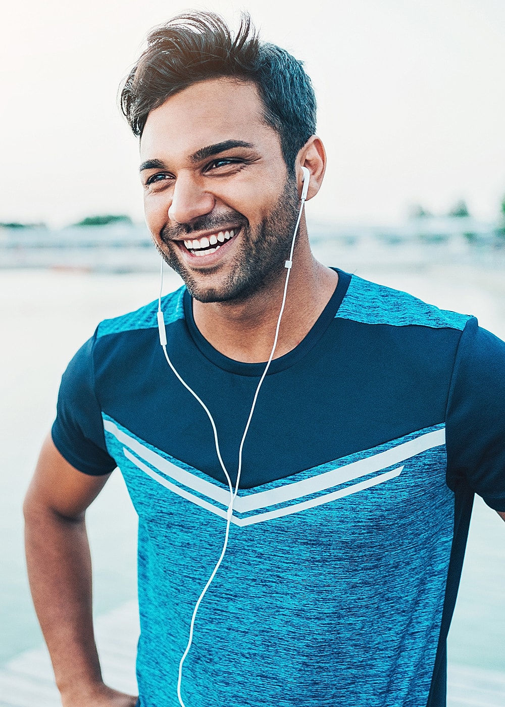Woman in stylish activewear outdoors at sunset.