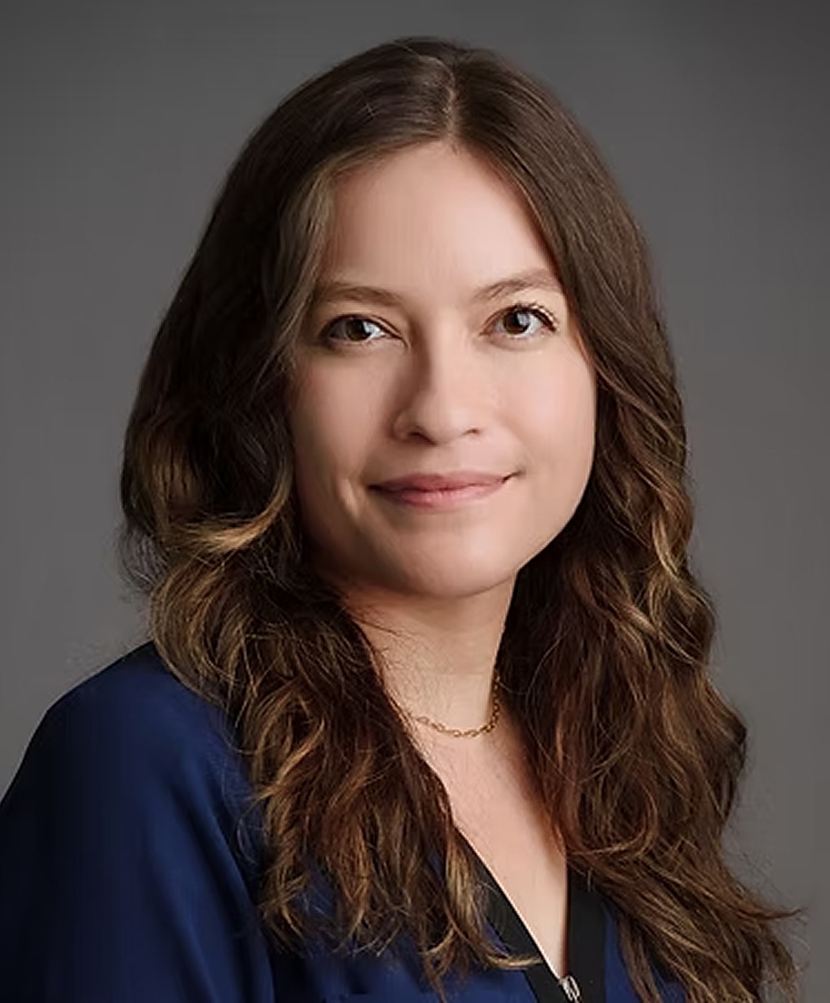 Smiling woman with long wavy hair portrait.