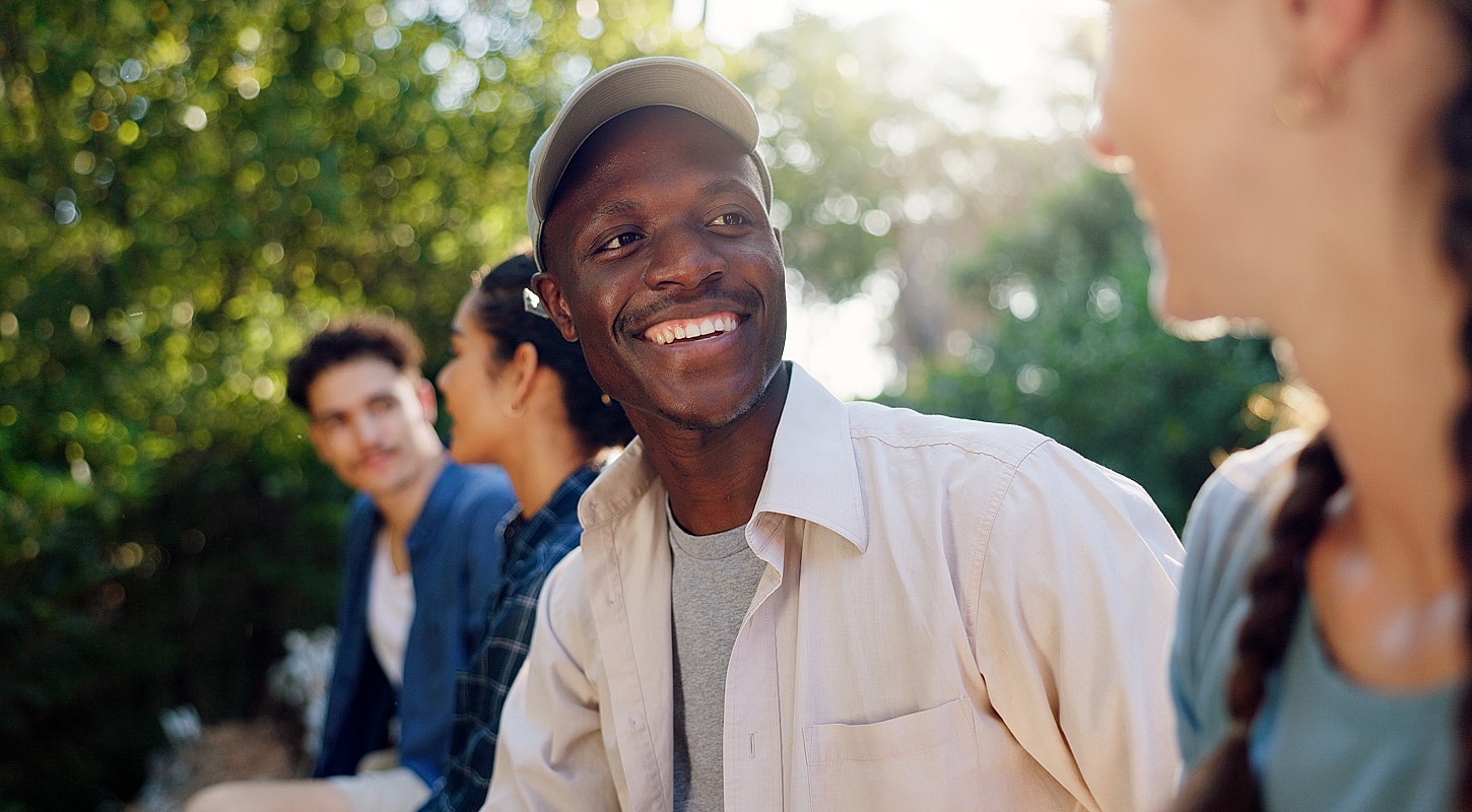 Group of friends enjoying a joyful conversation outdoors.